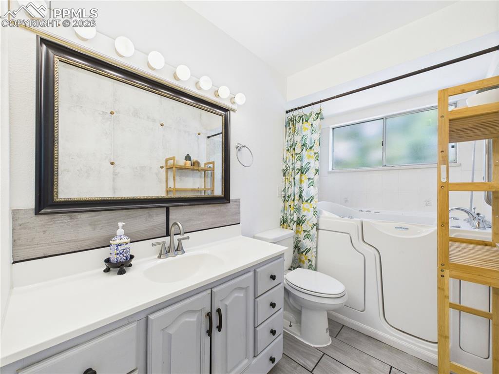 Image 12 of 39: Full bathroom with a bath and vanity