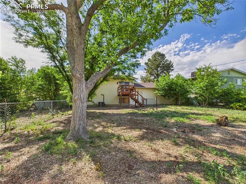 Image 34 of 39: View of yard with stairway and a wooden deck