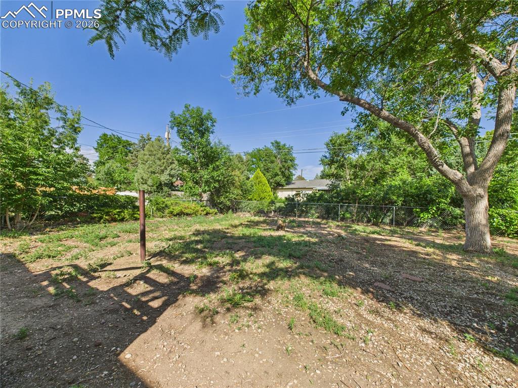 Image 35 of 39: View of fenced backyard