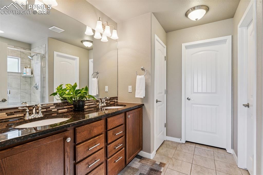 Image 29 of 47: Dual Vanities and Walk-in Closet