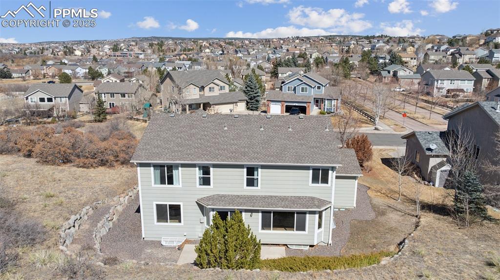 Image 10 of 43: View of front of home with a residential view and roof with shingles