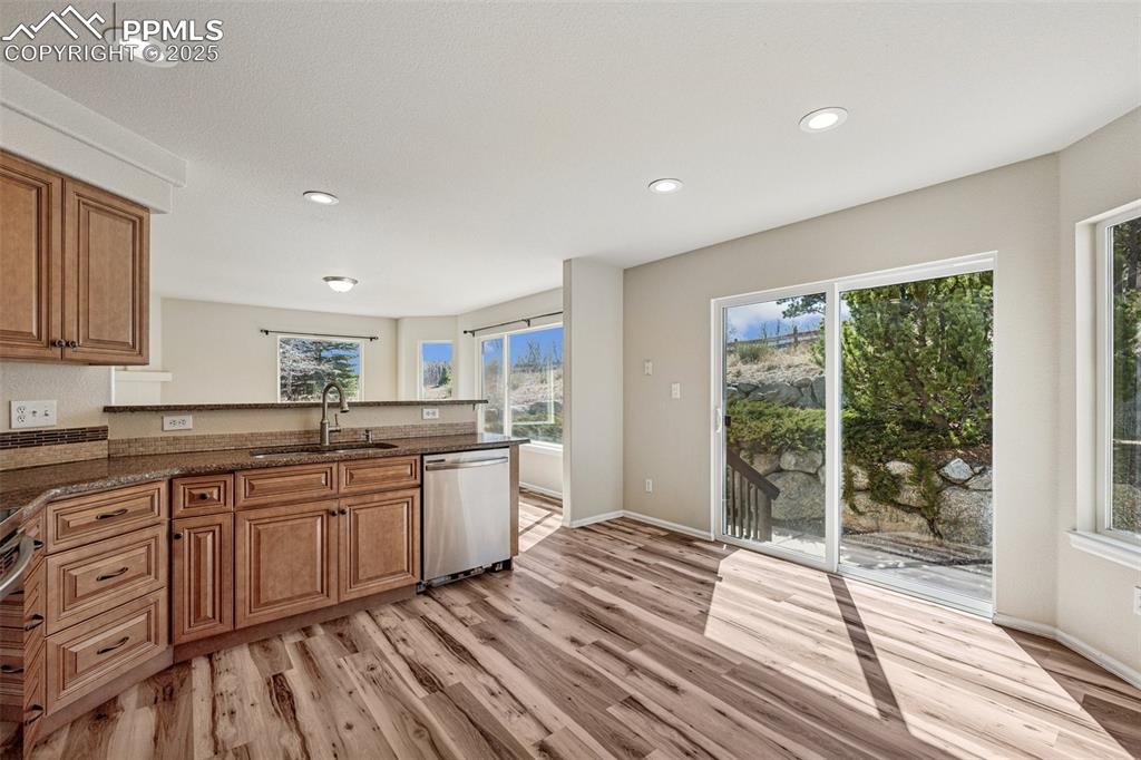 Image 20 of 43: Kitchen with dark stone counters, recessed lighting, a sink, stainless stee