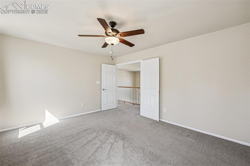Image 28 of 43: Primary bedroom featuring baseboards, ceiling fan, and carpet floors