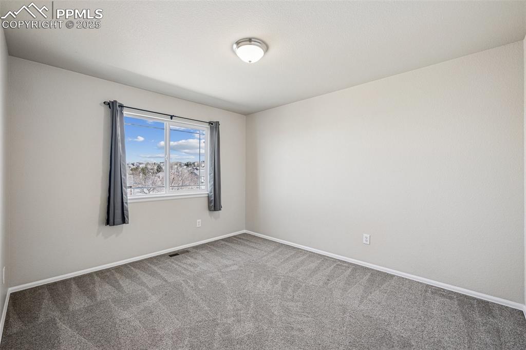 Image 34 of 43: Unfurnished room featuring baseboards, carpet floors, and visible vents