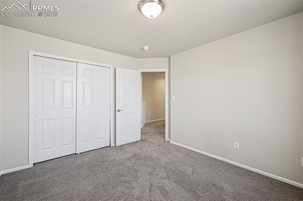 Image 35 of 43: Unfurnished bedroom featuring carpet flooring, baseboards, and a closet