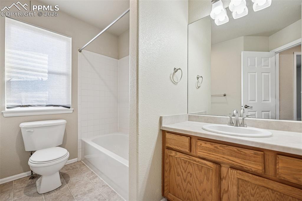 Image 36 of 43: Full bath with vanity, baseboards, tile patterned flooring, bathing tub / s