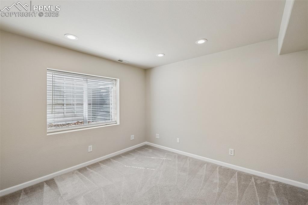 Image 39 of 43: Spare room featuring recessed lighting, light colored carpet, visible vents