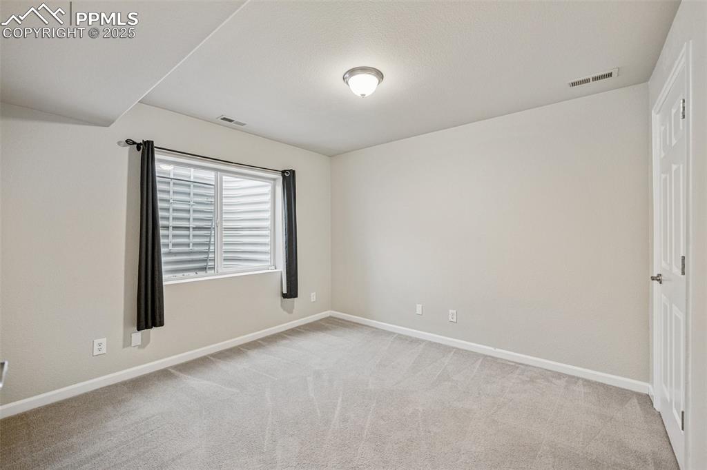 Image 41 of 43: Office featuring visible vents, baseboards, and light colored carpet