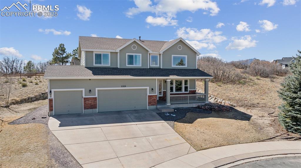 Image 7 of 43: View of front of house featuring covered porch, concrete driveway, an attac