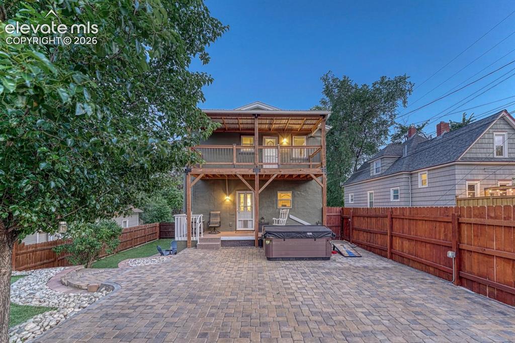 Image 4 of 50: Covered back patio - hot tub included!
