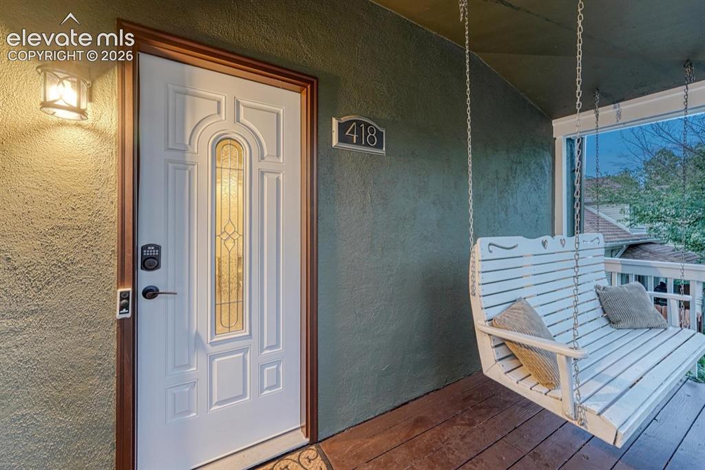 Image 5 of 50: Covered front porch with porch swing is a relaxing spot to sit and watch th