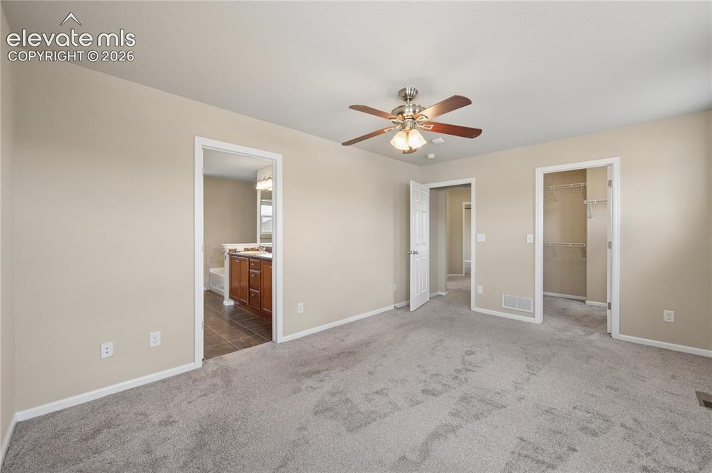 Image 14 of 20: Primary bedroom, attached 5-piece bathroom, walk-in closet