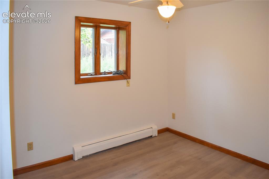 Image 27 of 44: Wood-finish flooring with coordinating wood trim