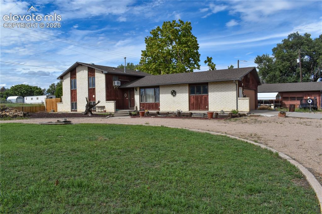 Image 3 of 44: Exterior featuring a combination of brick and wood siding, a gravel drivewa