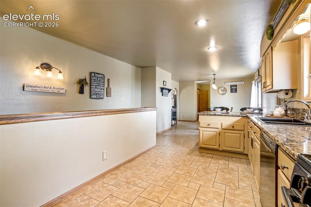 Image 11 of 48: view frm kitchen to dining area, stairwell to basement