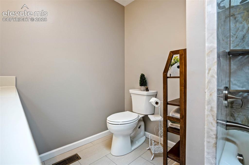 Image 23 of 48: Brand new full bathroom-main level hall, double sink/vanity, tiled flooring