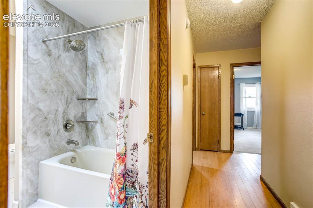 Image 24 of 48: hall view: new full bath to left, linen closet, 3 bedrooms