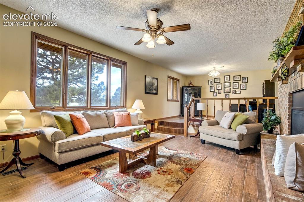 Image 3 of 48: Gorgeous Living Room Mountain views, wood plank flooring, gas fireplace