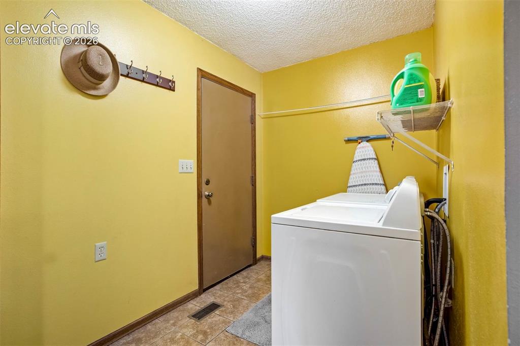 Image 35 of 48: MAIN LEVEL Washer/Dryer included. Door to garage, half bath (not in pic), t