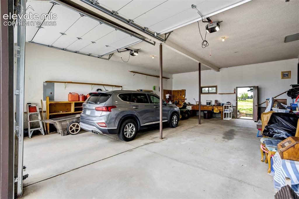 Image 40 of 48: OVERSIZED, can fit 4 cars 2 on each side. Tall garage doors measure 9
