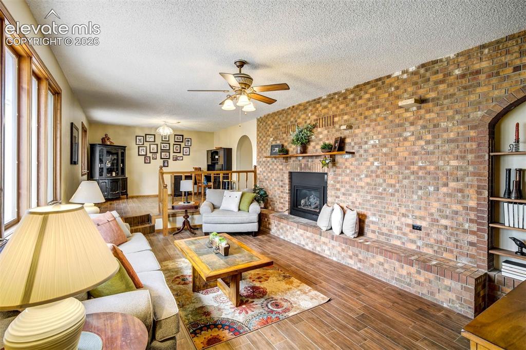Image 5 of 48: Living room
Beautiful wood plank tile flooring, brick walled gas fireplace