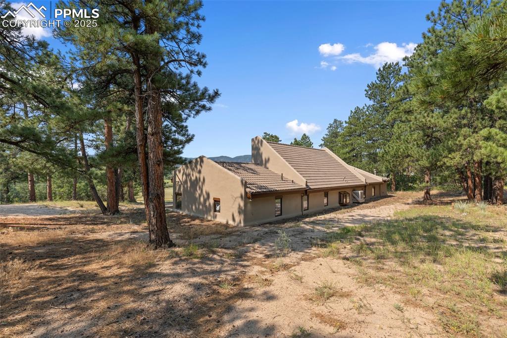 Image 16 of 50: Rear view of property with stucco siding and a tile roof