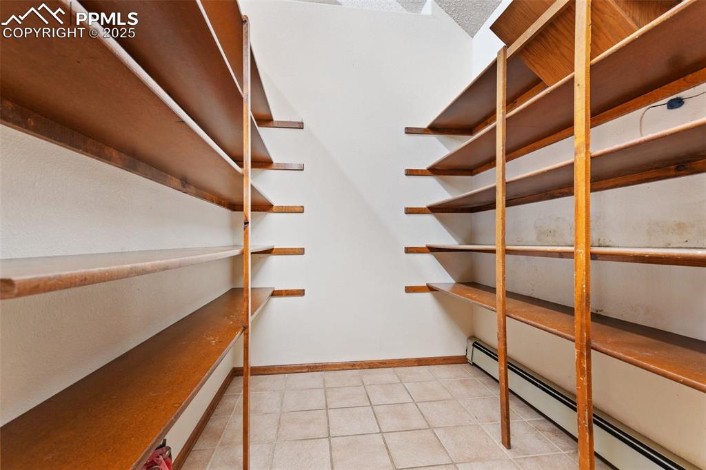 Image 29 of 50: Storage area with a baseboard heating unit