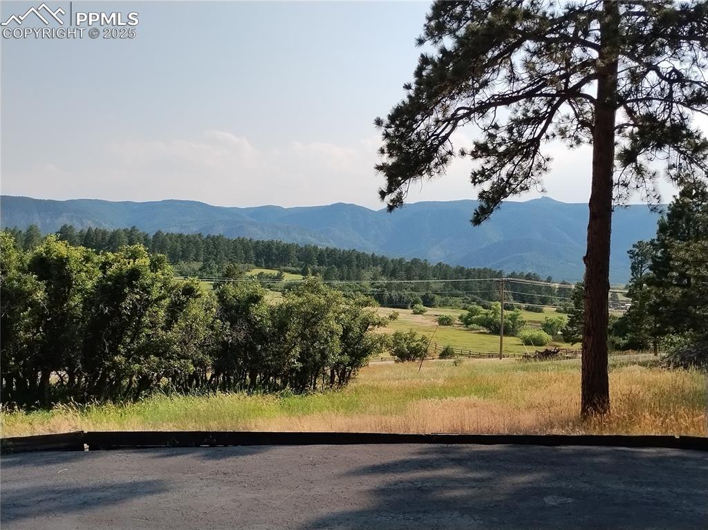Image 3 of 50: Mountain view with a heavily wooded area