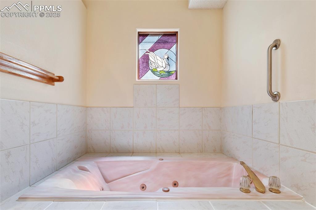Image 41 of 50: Full bathroom with a jetted tub