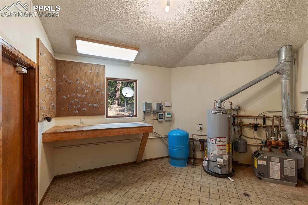 Image 47 of 50: Utility room with gas water heater