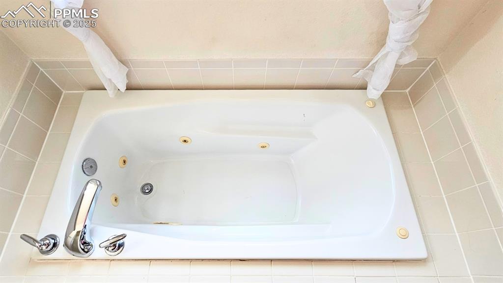 Image 15 of 28: Bathroom with a jetted tub