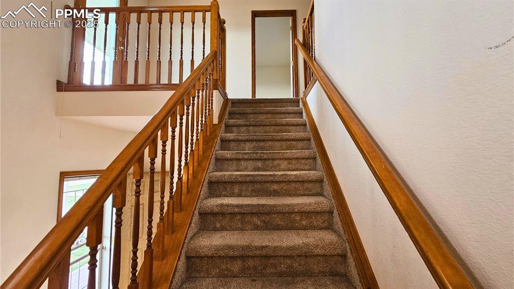 Image 16 of 28: Beautifully Designed Staircase with healthy amount of natural light and a h