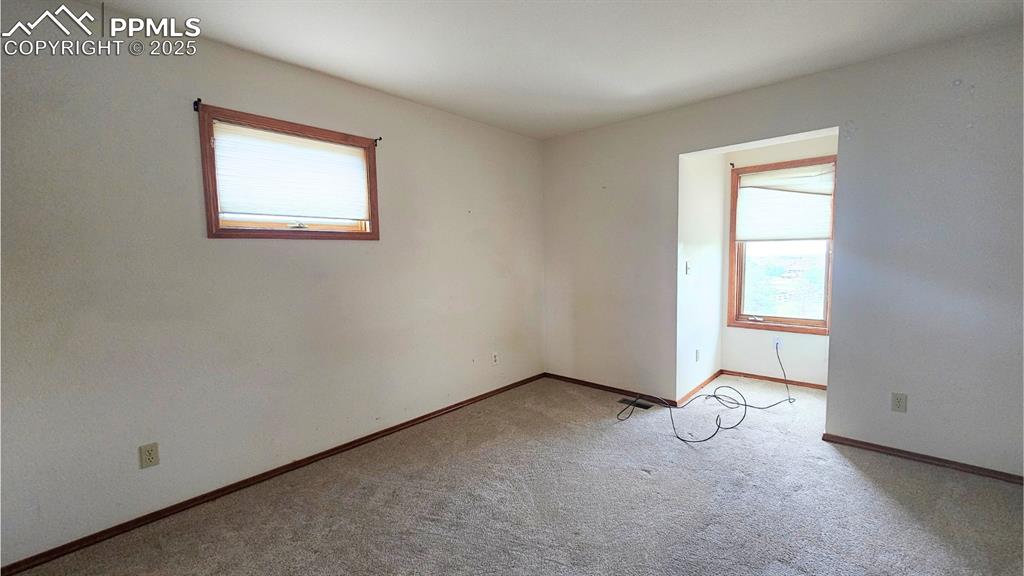 Image 18 of 28: Bedroom 2 - featuring light colored carpet and baseboards