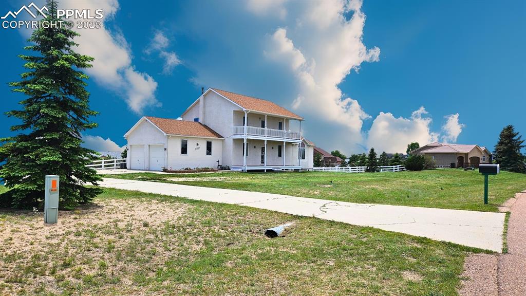Image 2 of 28: Featuring a balcony, expansive concrete driveway with space for 10+ Cars, a