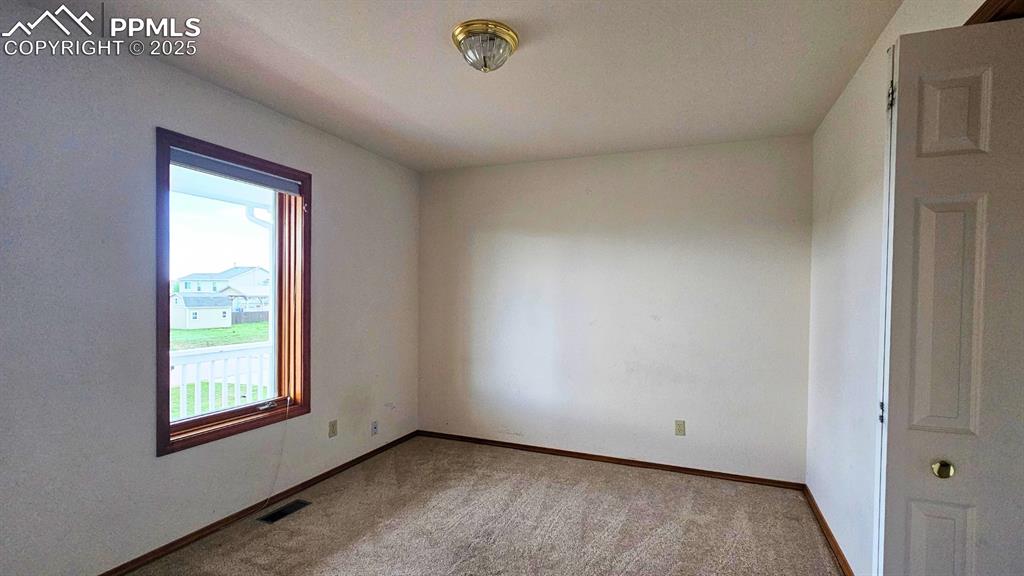 Image 20 of 28: Bedroom 4 with healthy amount of natural light and carpet