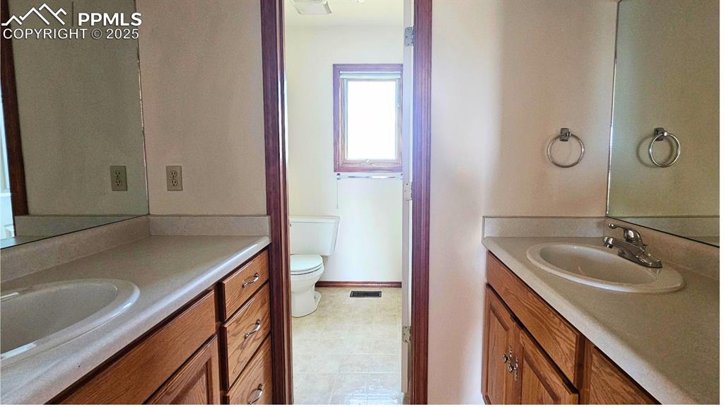 Image 21 of 28: Large Bathroom with dual vanity and private toilet