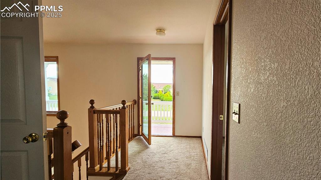 Image 22 of 28: Hall featuring an upstairs loft with walkout to deck.