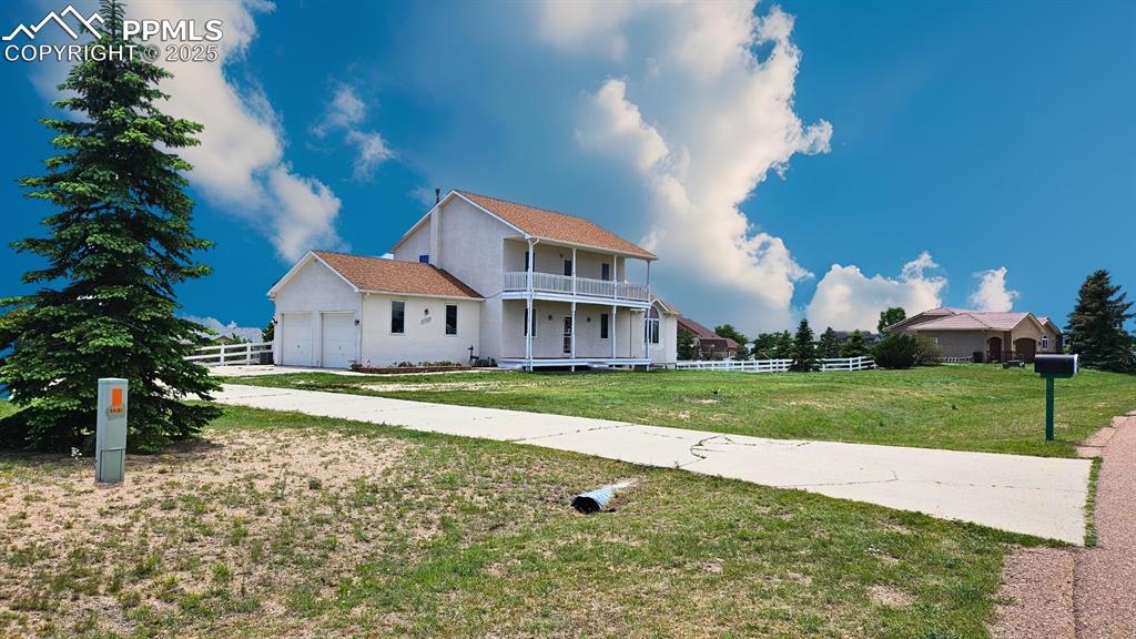 Image 27 of 28: Featuring a balcony, expansive concrete driveway with space for 10+ Cars, a
