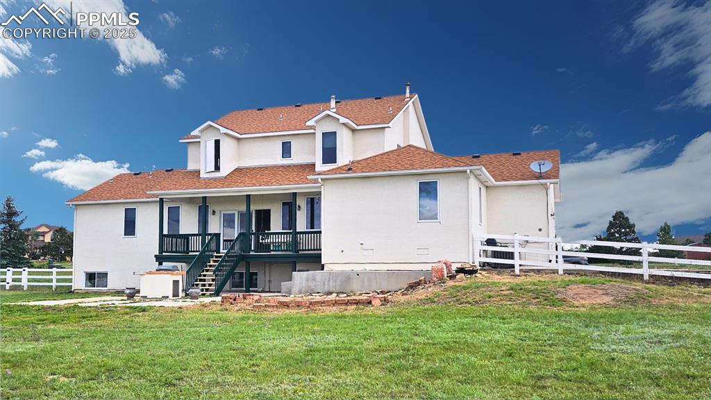 Image 28 of 28: Back of house featuring stairs to outdoor grill, stucco siding, covered dec