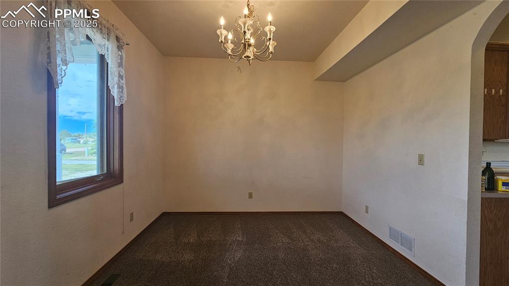 Image 6 of 28: Formal Dining with Walk-through to Kitchen and Butlers Pantry