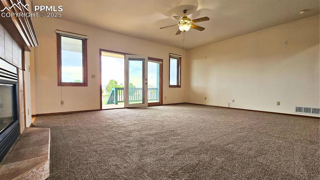 Image 8 of 28: Huge living room with Fireplace with Seating for 12+, Glass Doors to Deck #