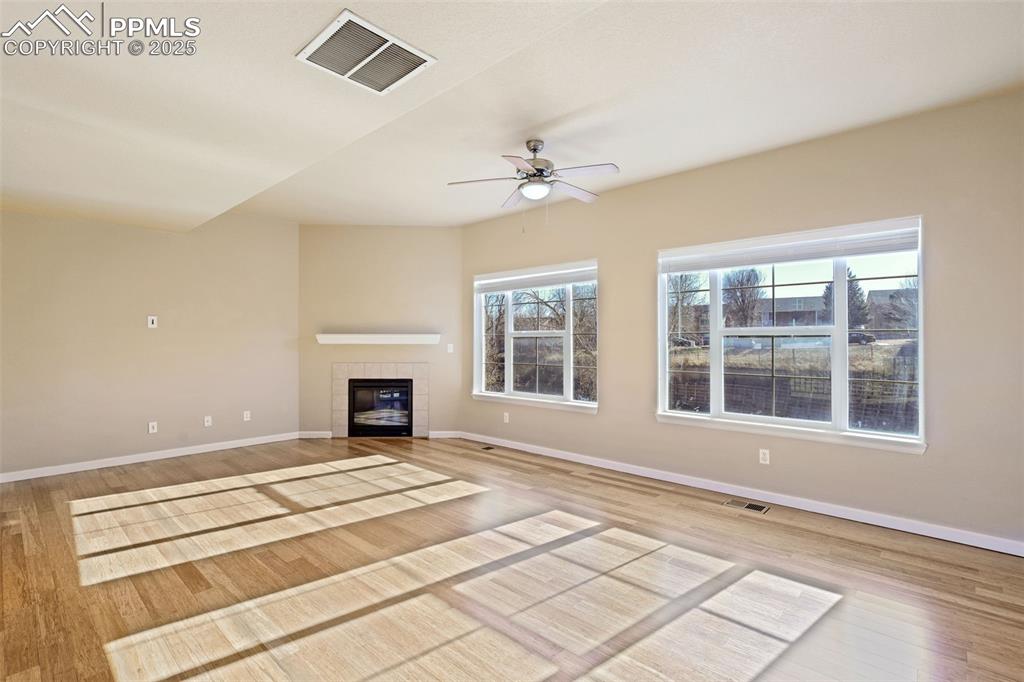 Image 9 of 37: Living room with laminate flooring and lots of natural light