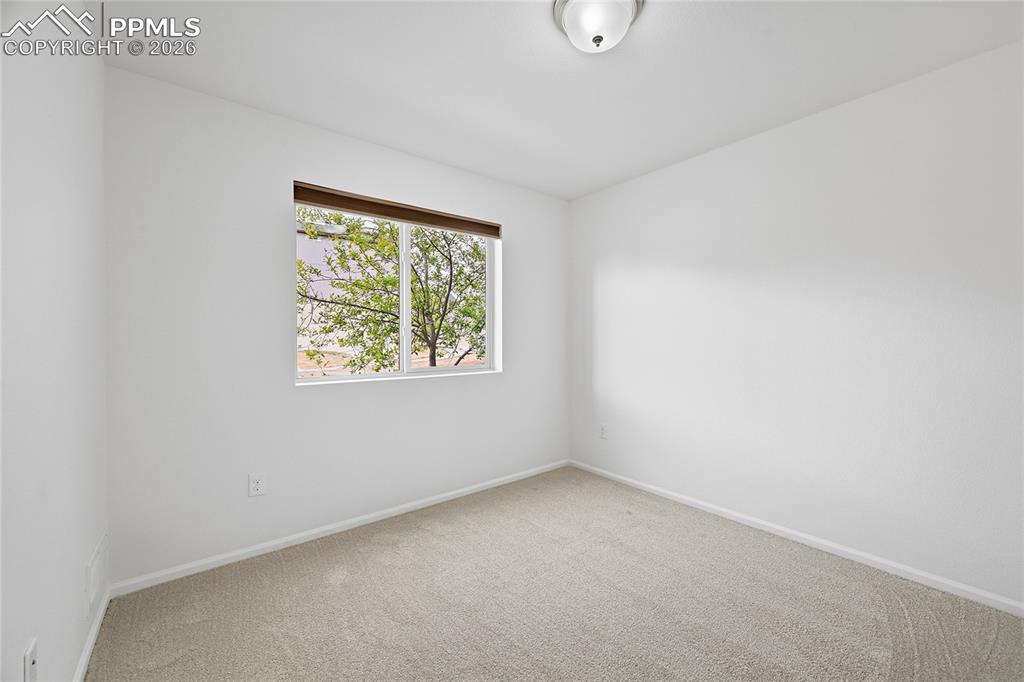 Image 23 of 40: Unfurnished secondary lower-level bedroom with light carpet flooring