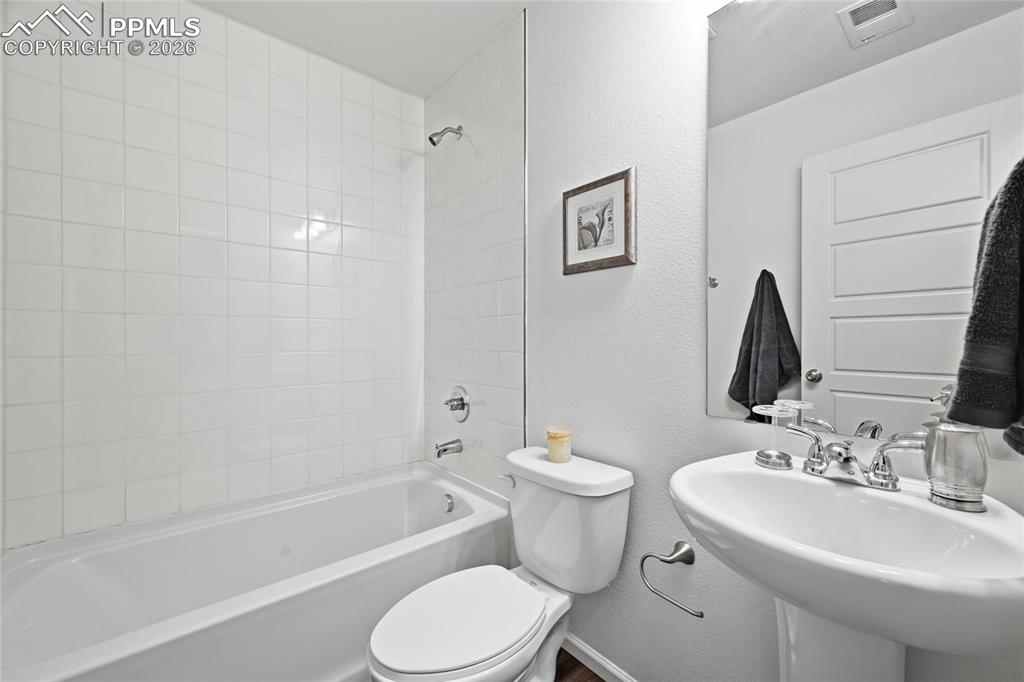 Image 25 of 40: Lower level full bathroom with a shower tub combination, and sink