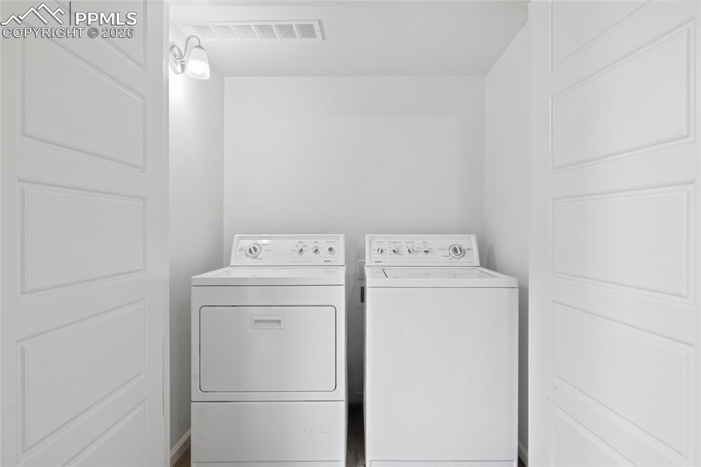 Image 28 of 40: Laundry closet with independent washer and dryer