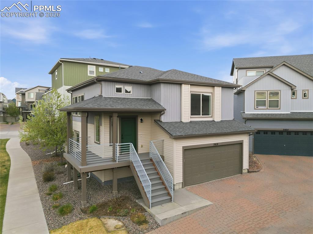 Image 33 of 40: View of front facade featuring roof with shingles, an attached garage, a re