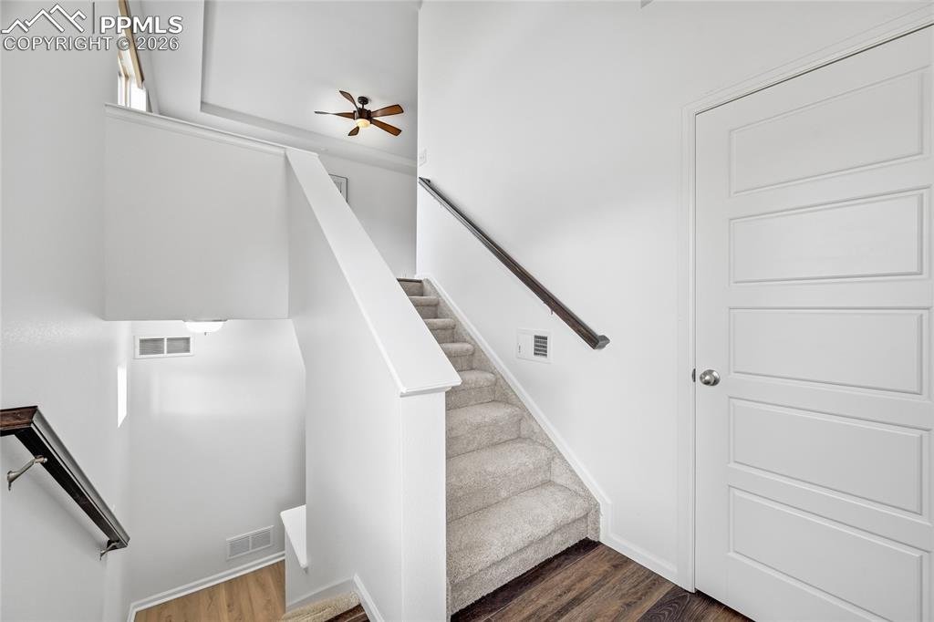 Image 5 of 40: Foyer Entry way Stairs and luxury vinyl wood finished floors