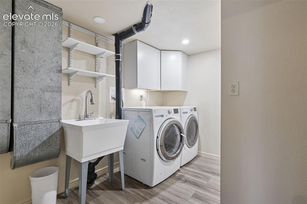 Image 19 of 32: Nice spacious laundry and mud room with laundry/utility sink