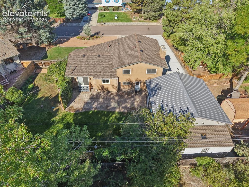 Image 25 of 32: rear of home with view of storage shed behind detached garage.