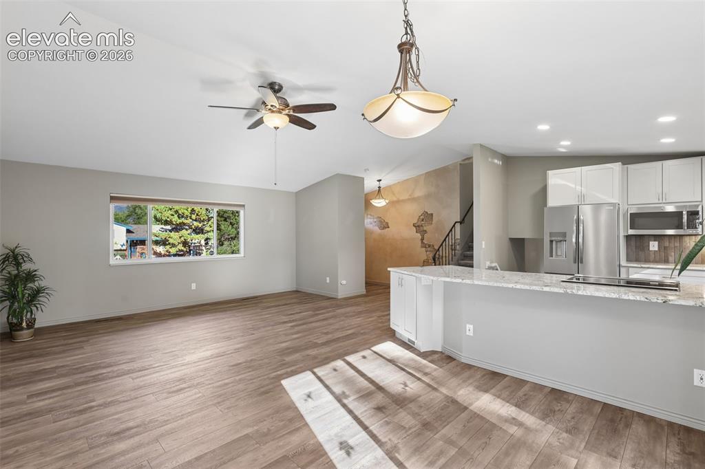 Image 5 of 32: Living/Dining/Kitchen with LVP flooring